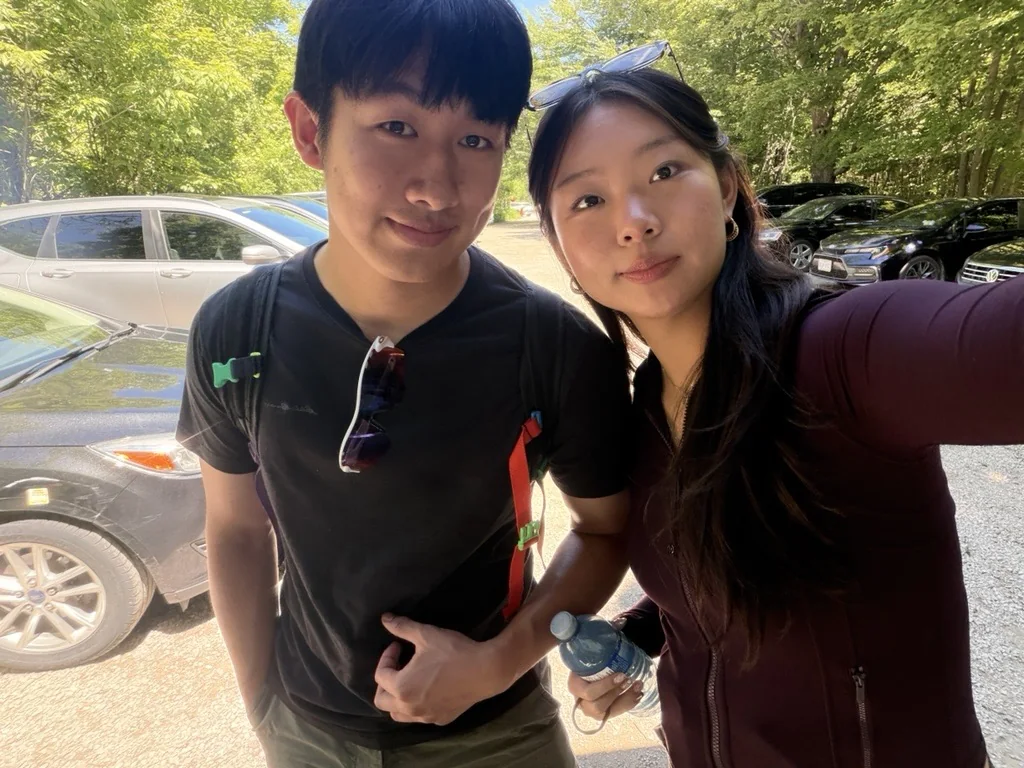 Amanda taking a sunny selfie with her boyfriend at the Lion's Head trailhead